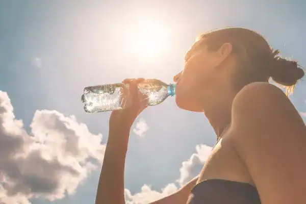 Hydration: The Secret Ingredient for a Toned Stomach and Enhanced Fitness 3 Image of woman drinking water to hydrate Yorkshire after run.